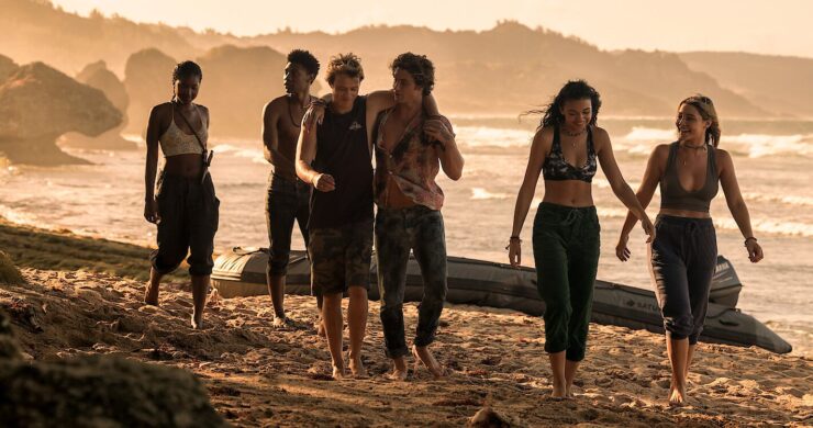 Cast of Outer Banks walks along the beach during an episode from season one.